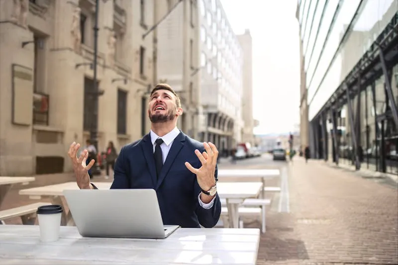 Frustrated business owner at laptop dealing with customer complaints
